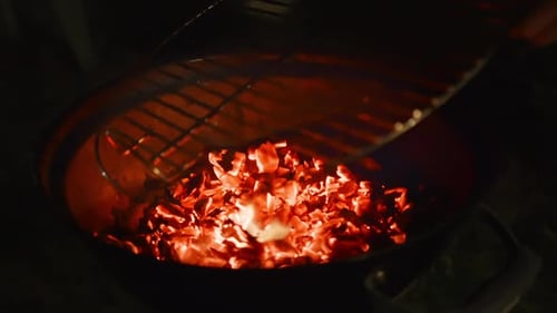 Barbecue Grill Pit With Glowing And Flaming Hot Charcoal Briquettes, Close-Up