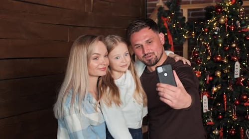 Happy Family Taking Christmas Selfie at Home