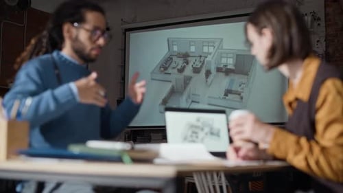 Architects Reviewing Blueprints Together in Meeting