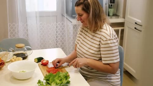 Vegetable Fresh Salad Woman Cooking a Green Salad with Cucumbers Onion Lettuce Pepper and Tomatoes