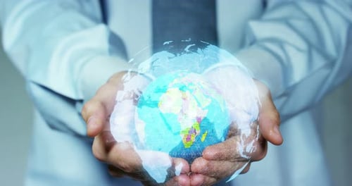 The young businessman holding in his hands the model of a globe. Concept of global business and co