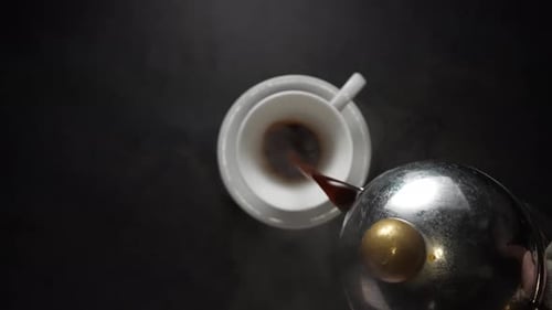 Pouring Hot Coffee Into a Teacup