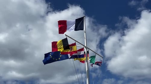 Flags from several countries on a pole waving