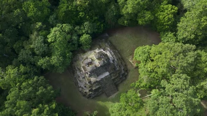Aerial View Of Maya Ruins In Jungle Guatemala Overhead Stock Footage aerial-view-of-maya-ruins-in-jungle-guatemala-overhead-stock-footage