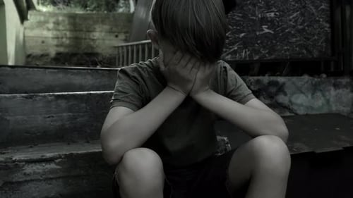Lonely Boy Sitting on Urban Concrete Stairs