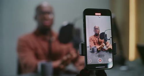 Man Recording Podcast Video On Smartphone Camera
