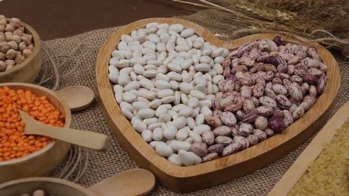 Various dried grains and legumes arranged on table