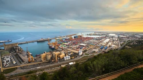 Timelapse view of Barcelona sea port with massive amount of containers, moored ships, moving trucks