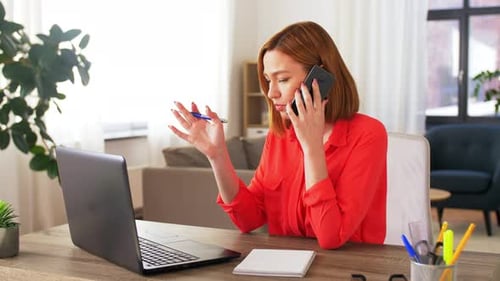 Woman working from home on laptop and phone