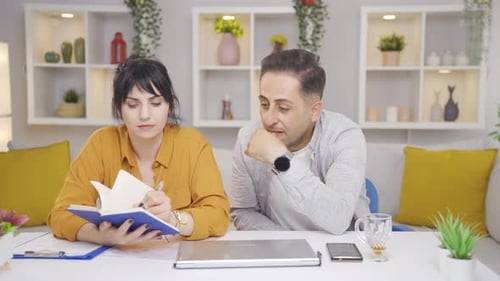 Man and Woman Collaborate at Home Office