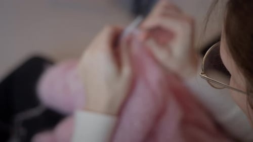 Overhead View of Woman Knitting Cozy Pink Sweater