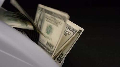 One Hundred Dollar Bills Being Counted by Machine