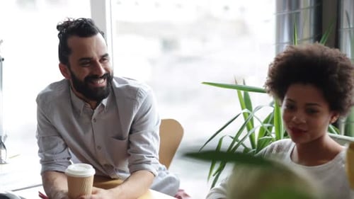 Coworkers Chatting Together During Break Time at Work