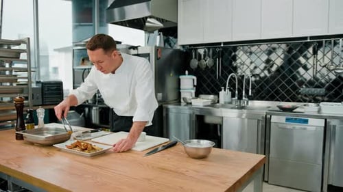 Chef Plating Potato Wedges in Professional Kitchen