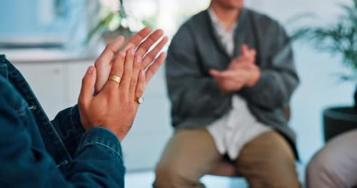 Adults Clapping Hands in Indoor Workplace Setting