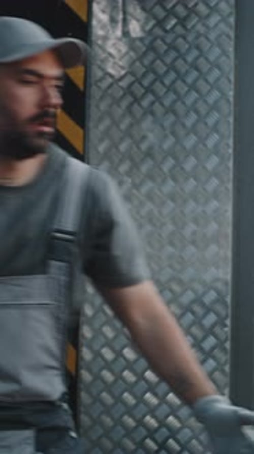 Worker Carrying Brown Boxes in Workplace