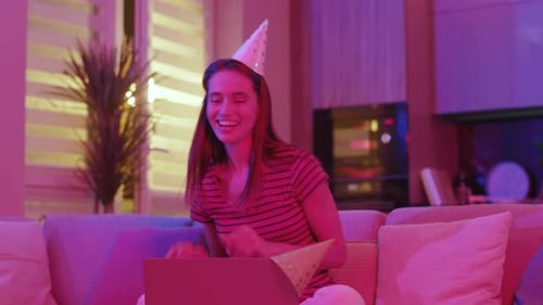 Woman celebrating birthday on video call at home