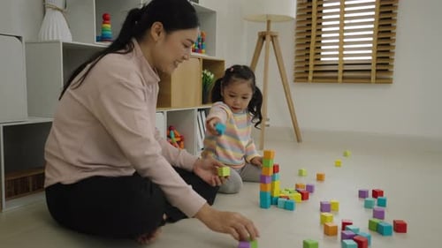 Mother and Child Playing with Colorful Building Blocks
