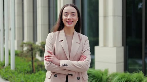 Young Professional Crossing Arms and Smiling with Confident Look