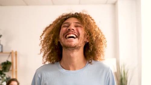 Smiling Young Adult with Curly Hair