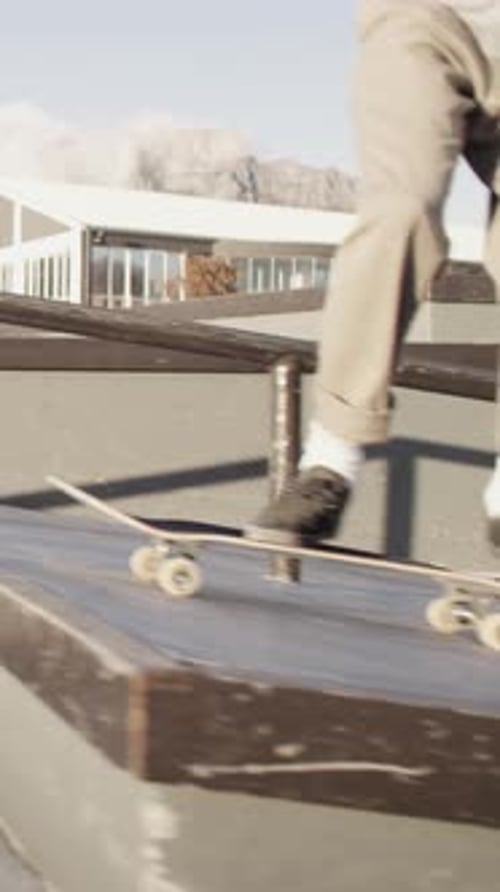 Legs, person and jump with skateboard in city for trick, training and extreme sports with action