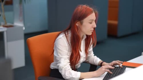 Young Redhead Woman Typing on Keyboard Sitting in Office Thanking Unrecognizable Man for Coffee