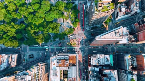Cars move by the Fifth Avenue near the Madison Park and Flatiron building.