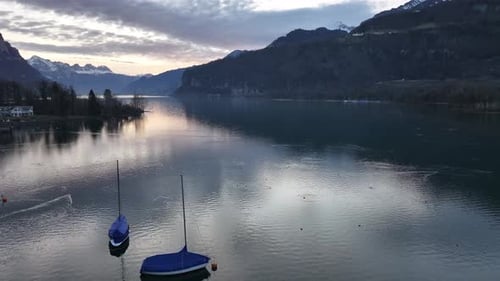 Scenic Lake and Mountains Under Sunrise Sky
