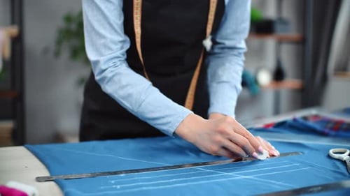 Woman Dressmaker Hands Drawing Pattern Textile Sewing Clothes Use Ruler and Chalk at Workshop Desk