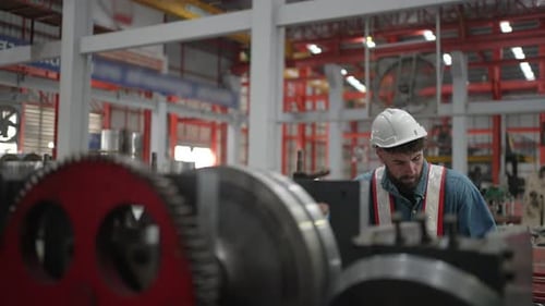 Blue collar worker work at metal sheet factory.