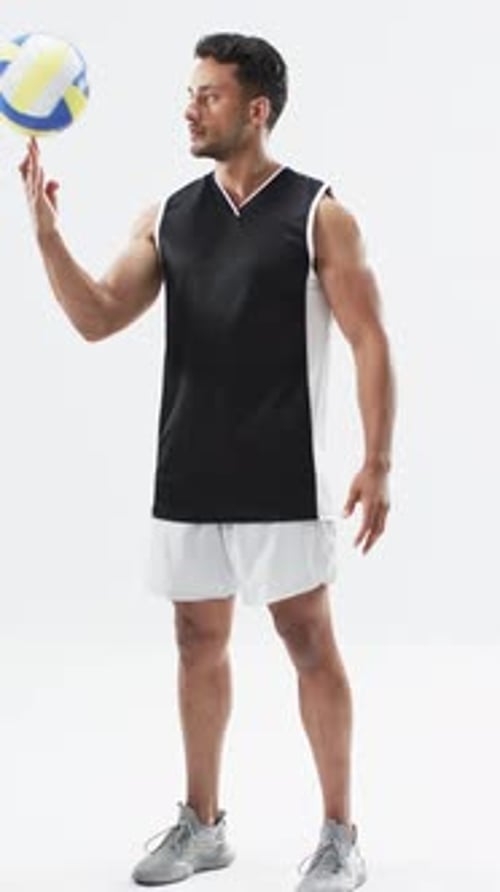 Athletic Man Spins Volleyball on Finger