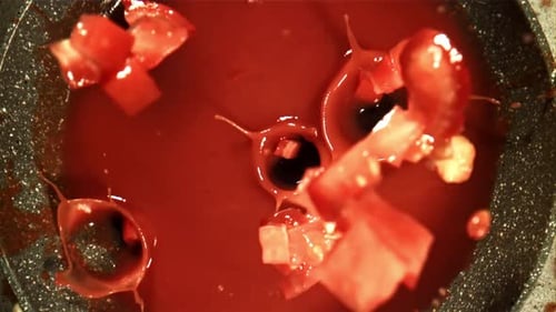 Pieces of Chopped Tomatoes Fall Into the Sauce Filmed on a Highspeed Camera at 1000 Fps