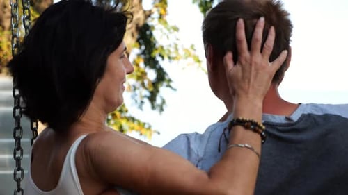 Romantic Couple Hugs During Sitting Together on Swing at the Sea Beach Happy Lovers Enjoy to