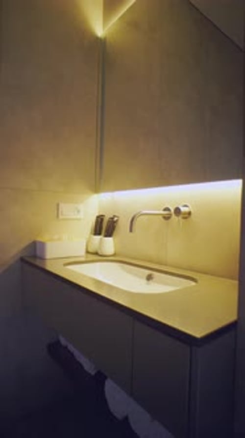 Warm Back Lit Sink In Concrete Bath
