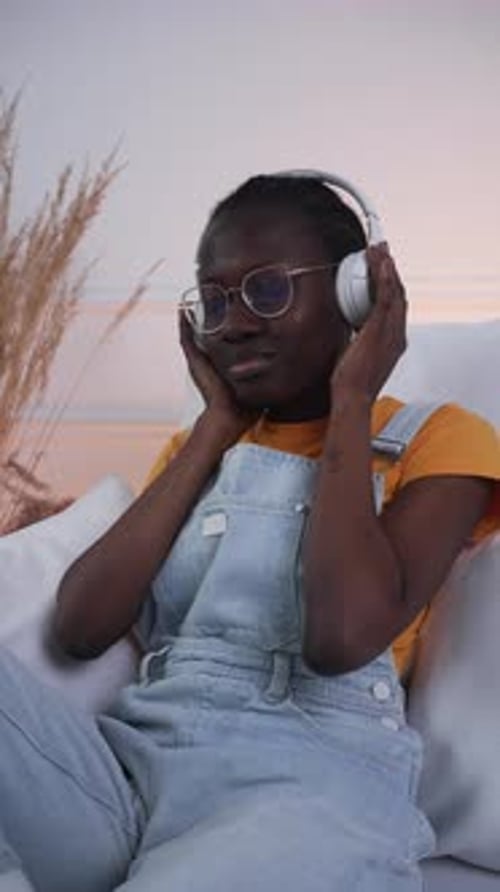 Woman Relaxing and Listening to Music on Headphones