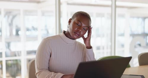 Headache, burnout and black woman with stress in office on laptop working on report