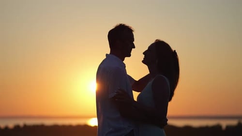 Romantic Couple Kissing Silhouetted at Sunset