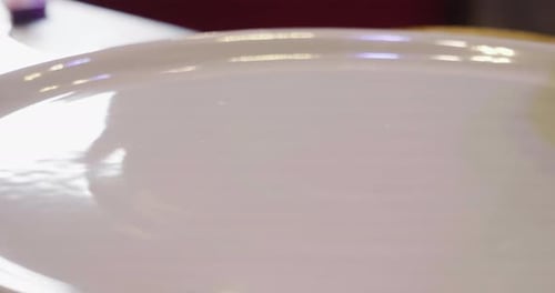 Close up of a pizza chef's hands filling a pizza with high quality Italian gastronomic ingredients