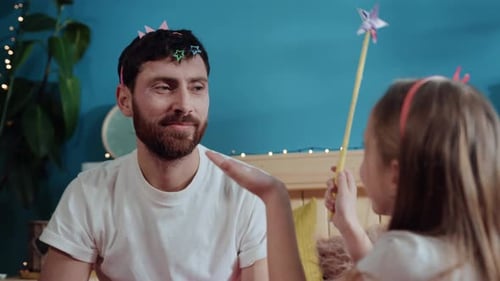 Father and Daughter Playfully Dressing Up at Home