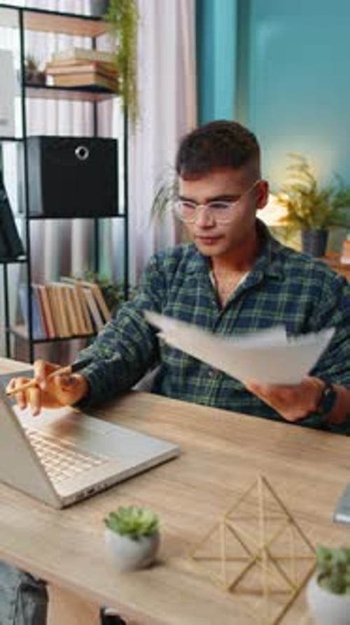 Freelancer Man Accountant Works with Financial Graph Documents Calculate Taxes for Charts at Office