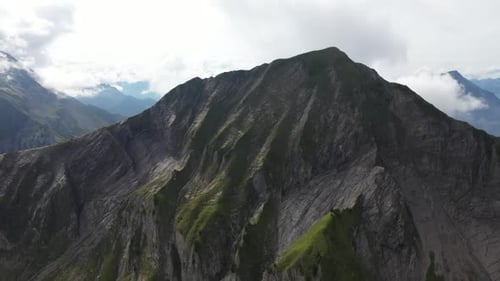 Drone shot showing the rocky cliff side of Morgenberghorn mountain in Switzerland. Bare with grey ro