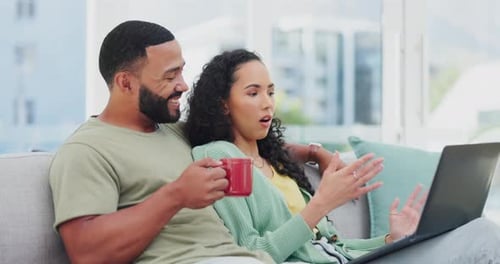 Relaxed Couple Using Laptop on Grey Couch