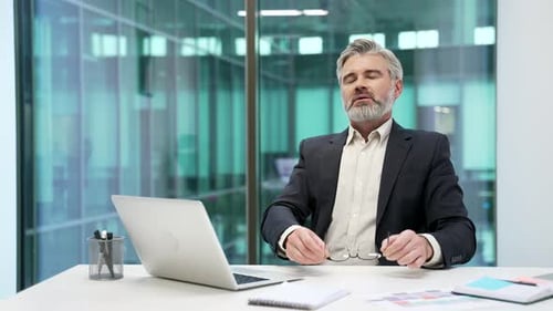 Businessman took break from work on laptop sitting at desk at workplace in business office.