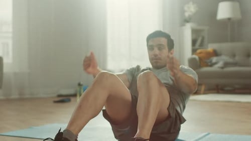 Man Doing Sit-Ups on Exercise Mat at Home