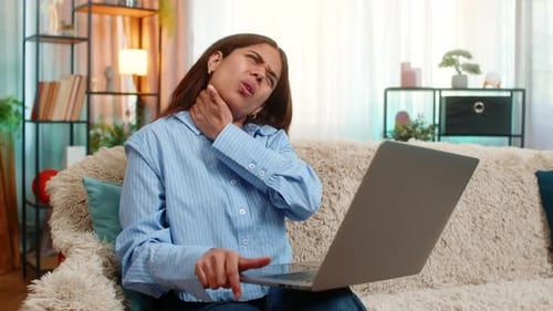 Woman with Neck Pain Sitting on Couch
