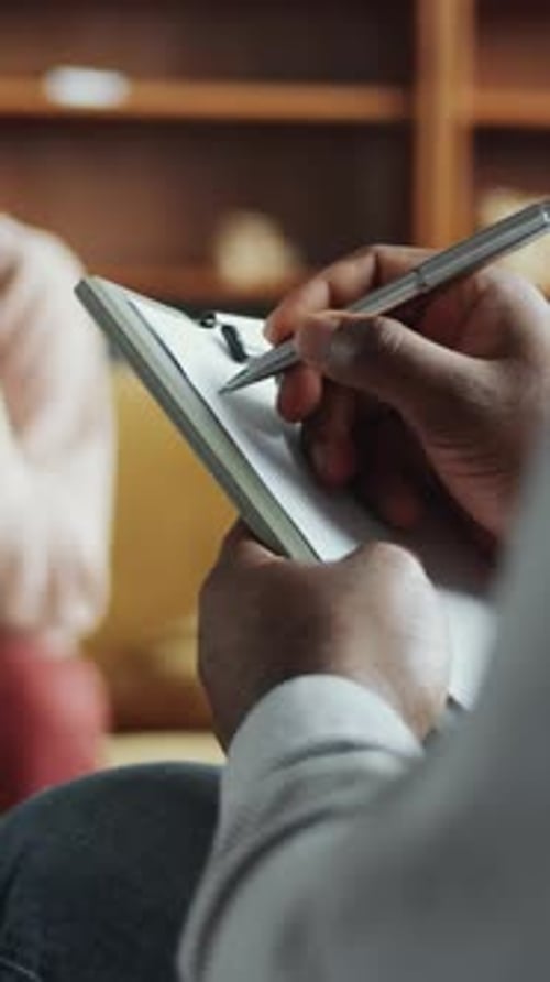 Therapist Taking Notes During Therapy Session