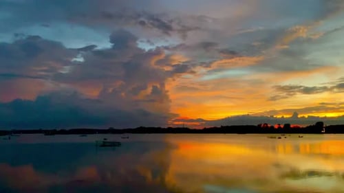 The beautiful sunset over the calm waters of the lake makes for a perfect view