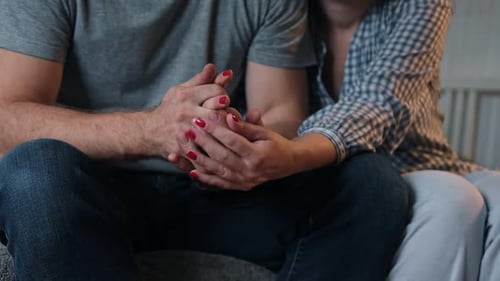 Couple Holding Hands in Loving Embrace Indoors