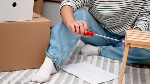 Close Up Woman Assembles Modern Wooden Shelf with Ease Enhance Her New Living Space After Moving