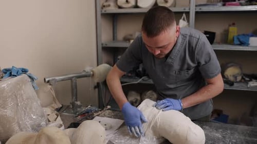 Medical Professional Working on a Mold